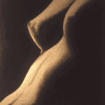 Artistic nude study emphasizing light and shadow on the human form.